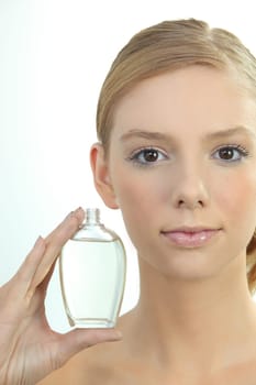 Young woman holding a bottle of perfume