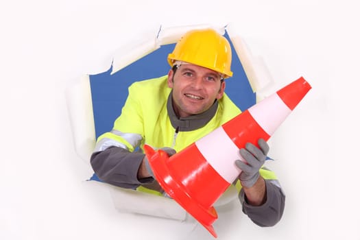 Worker holding a traffic pylon