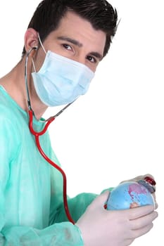 Doctor using stethoscope on globe