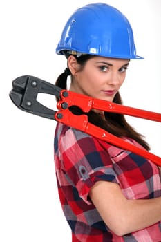 Female construction worker holding a pair of heavy-duty clippers