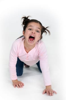 child girl on all fours is screaming