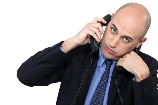 Businessman using two phones