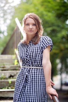 Woman in blue checkered dress posing