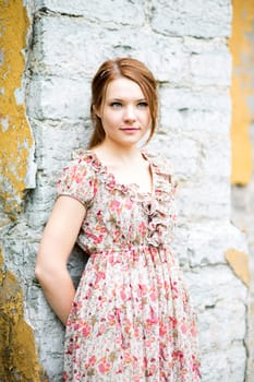 Young woman in flowered dress looking far away