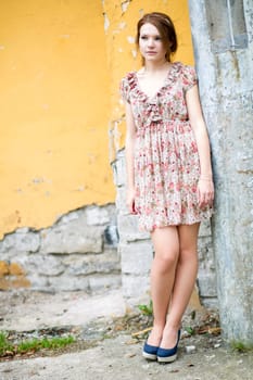 Young woman in flowered dress waiting some friend
