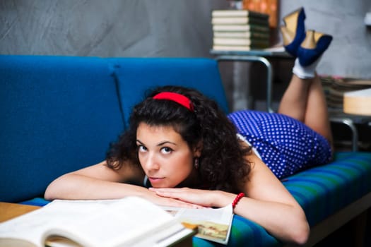 Woman lay on soft sofa and look up