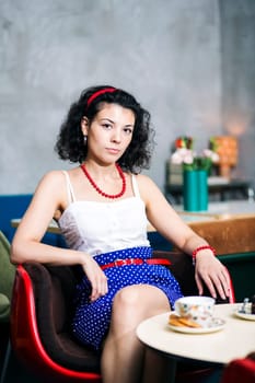 Woman on chair in café with serious look