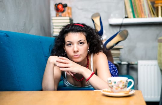 Young woman lay on soft sofa and looking