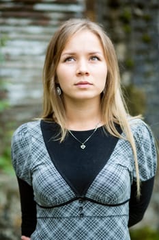 Young woman posing at camera and looking up