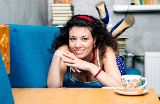 Woman lay on soft sofa and smile widely
