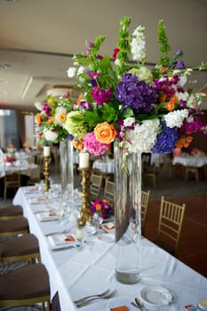 Image of the head table at a wedding with florals