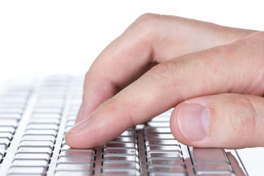 Close-up view of hand typing on a computer keyboard