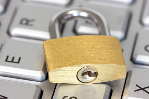 Concept of computer safety, golden lock on the keyboard
