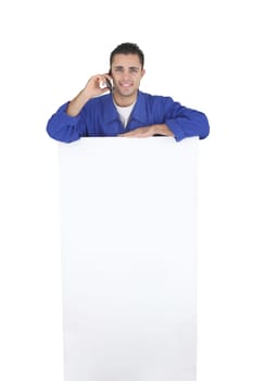 Electrician stood by blank poster surrounded by equipment