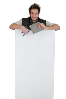 tiler holding an ad board