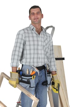 Carpenter standing by a ladder