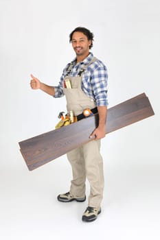Man with laminate flooring giving thumbs-up