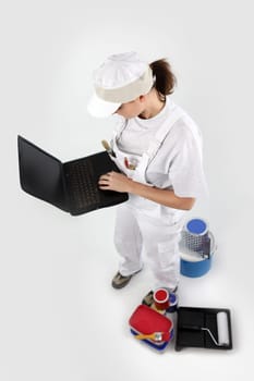 craftswoman painter holding a laptop