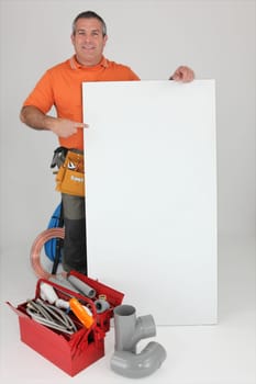 Plumber with materials and a board left blank for your message