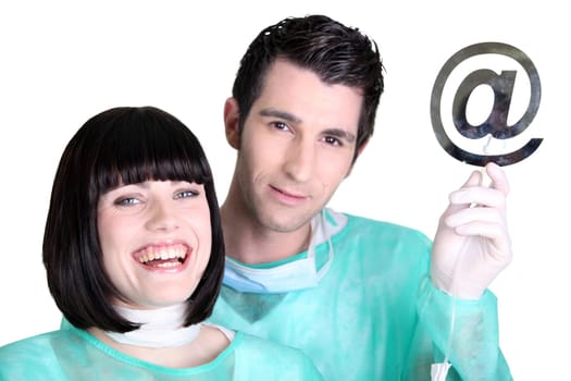 Doctors holding up the at symbol