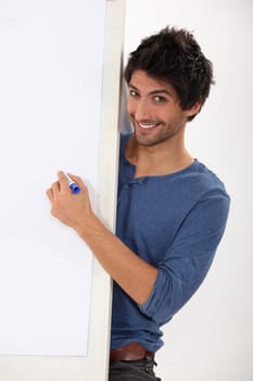 Man about to write on a blank presentation board