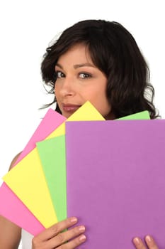 a woman showing paint sample cards