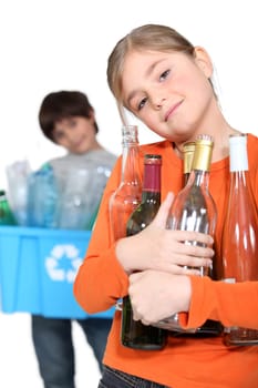 Children recycling glass bottles