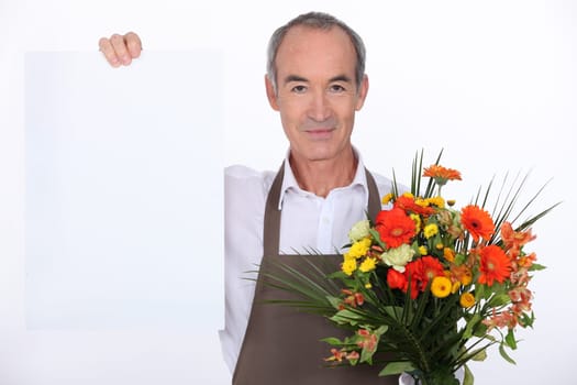 Male florist holding message board