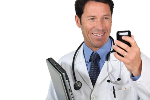 Doctor with a cellphone and laptop computer