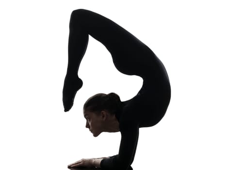 one caucasian woman contortionist practicing gymnastic yoga  in silhouette   on white background