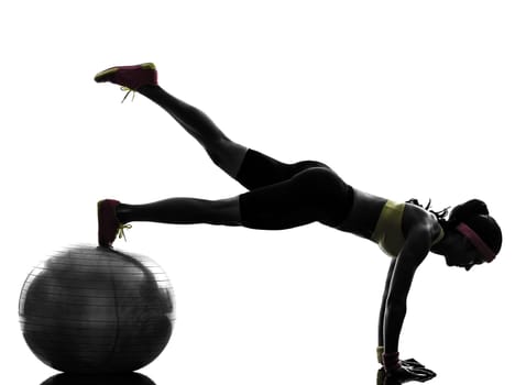 one  woman exercising fitness workout plank position on fitness ball in silhouette  on white background