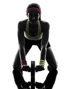 one  woman exercising fitness workout abdominal toning wheel in silhouette  on white background