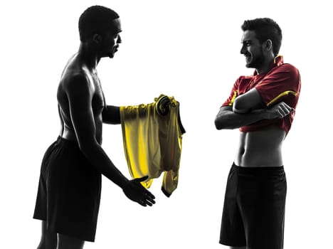 two men soccer player playing football competition exchanging jersey  in silhouette  on white background