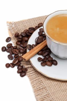 Still life about coffee with a delicious  espresso and some coffee beans and cinnamon.