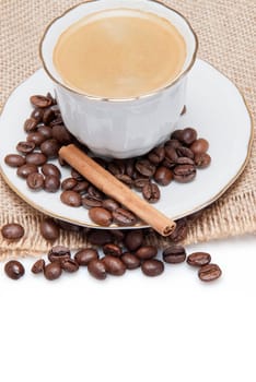 Still life about coffee with a delicious  espresso and some coffee beans and cinnamon.