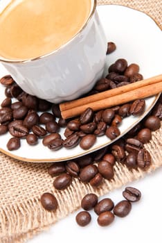 Still life about coffee with a delicious  espresso and some coffee beans and cinnamon.