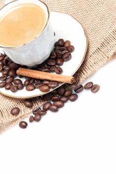 Still life about coffee with a delicious  espresso and some coffee beans and cinnamon.