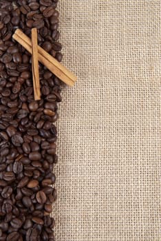 Background of burlap and coffee beans with a copy space.