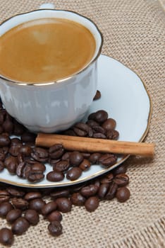Still life about coffee with a delicious  espresso and some coffee beans and cinnamon.