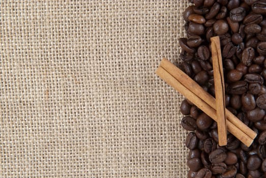 Background of burlap and coffee beans with a copy space.