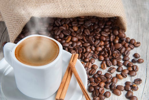 Still life about coffee with a delicious  espresso and some coffee beans and cinnamon.