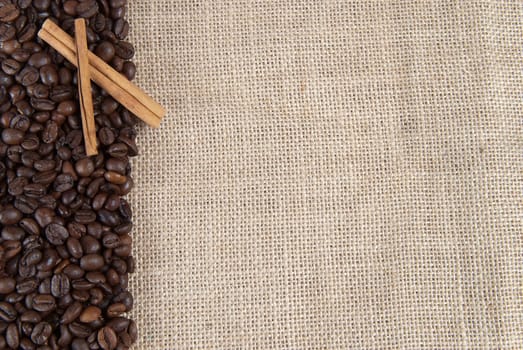 Background of burlap and coffee beans with a copy space.