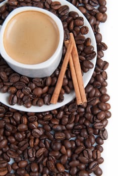 Still life about coffee with a delicious  espresso and some coffee beans and cinnamon.