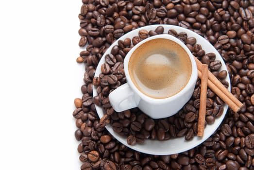 Still life about coffee with a delicious  espresso and some coffee beans and cinnamon.
