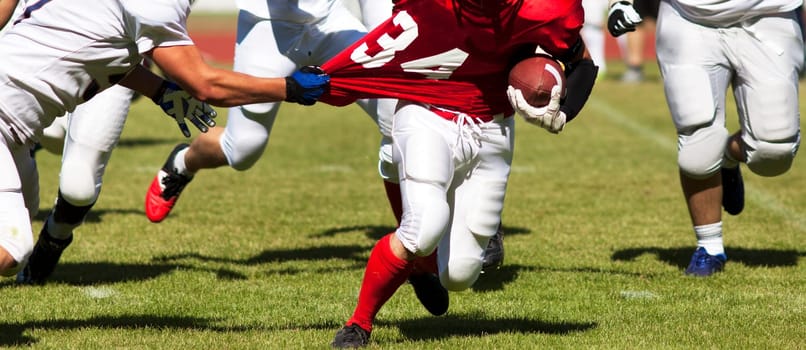 american football game with out of focus players in the background