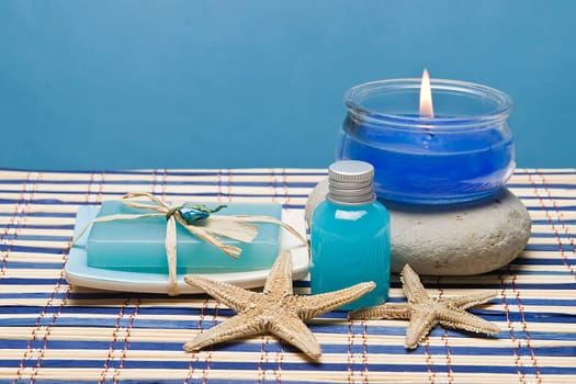 Spa background with blue hygiene items and toiletries.