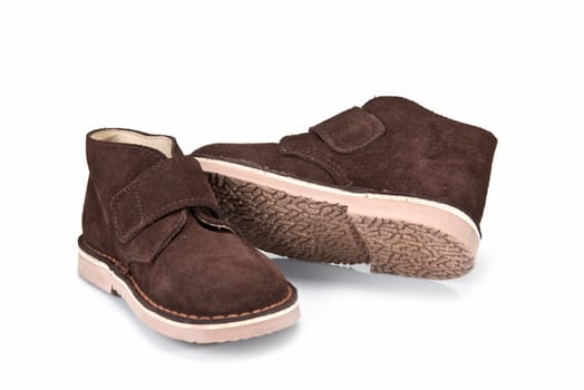 Brown leather boots for kids isolated on a white background.