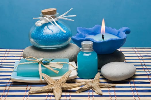Spa background with blue hygiene items and toiletries.