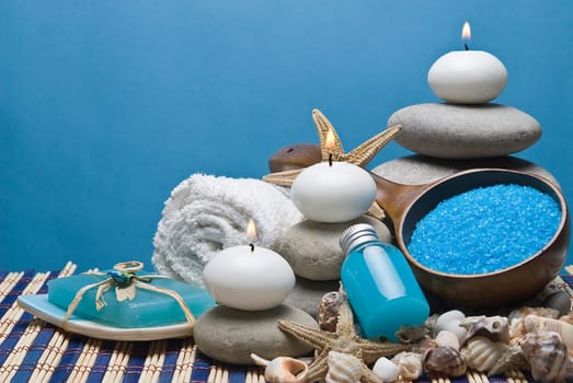 Spa background with blue hygiene items and toiletries.