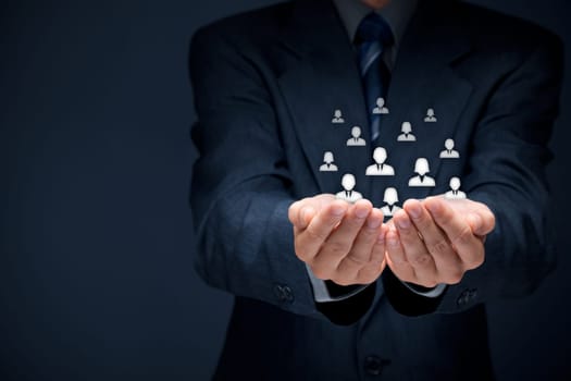 Customer care, care for employees, labor union, CRM, and life insurance concepts. Protecting gesture of businessman or personnel and glass cubes with icons representing group of people.